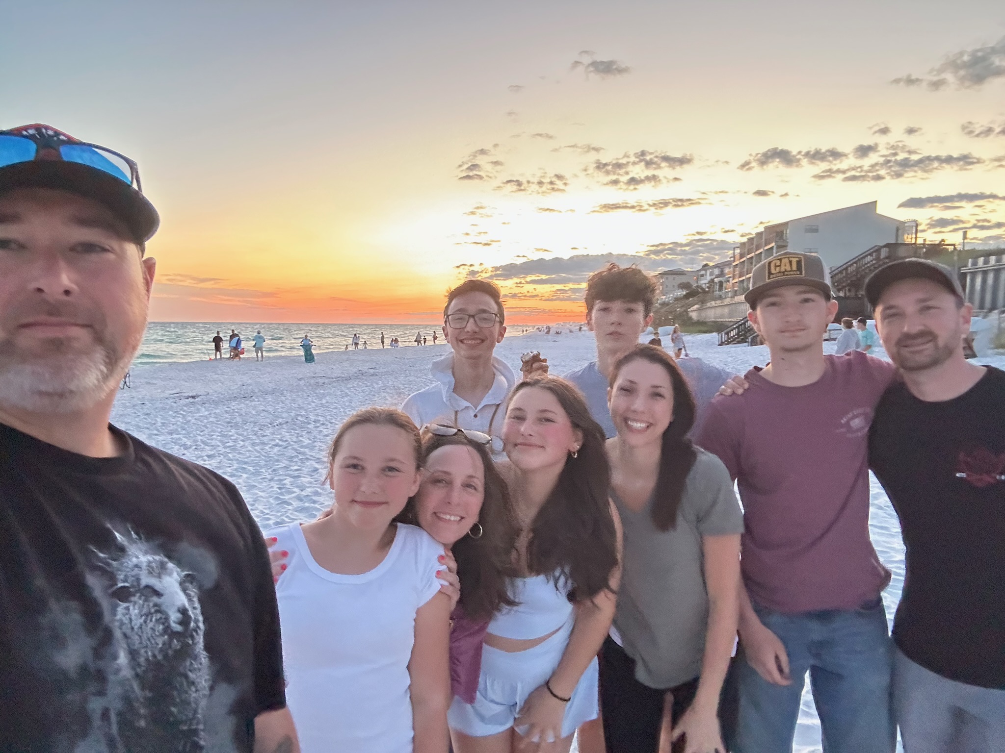 Photo of the Lobuglio's and friends on the beach at sunset.