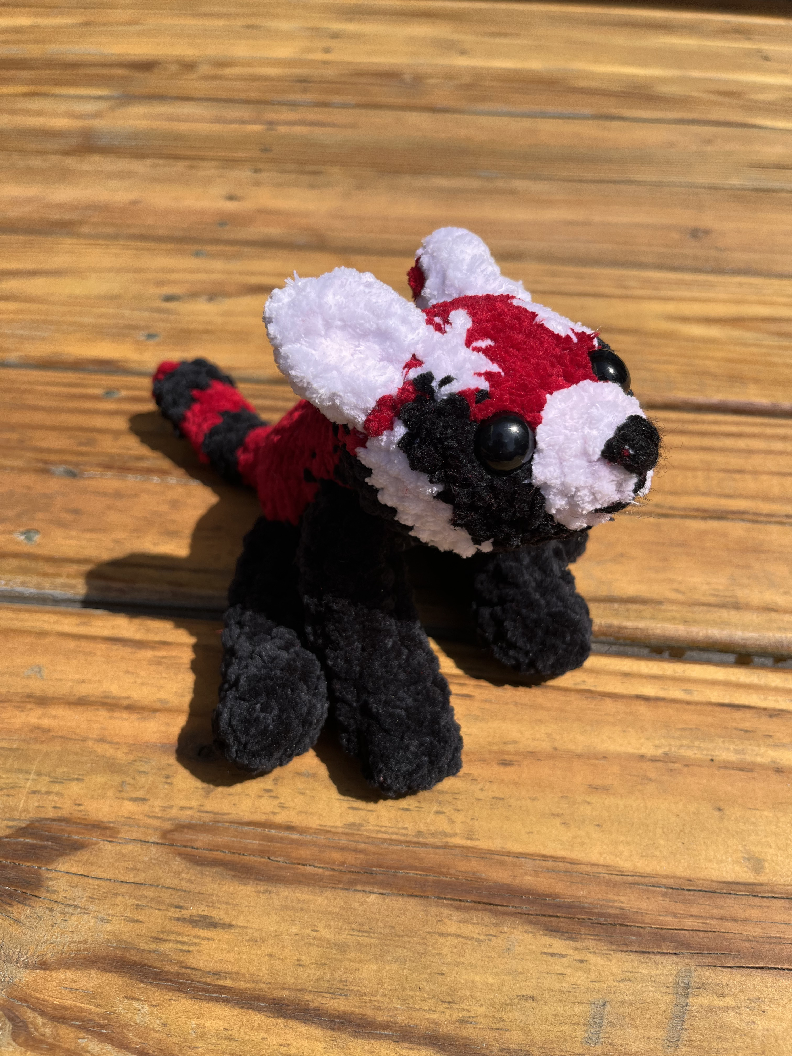 Photo of a crocheted red panda.